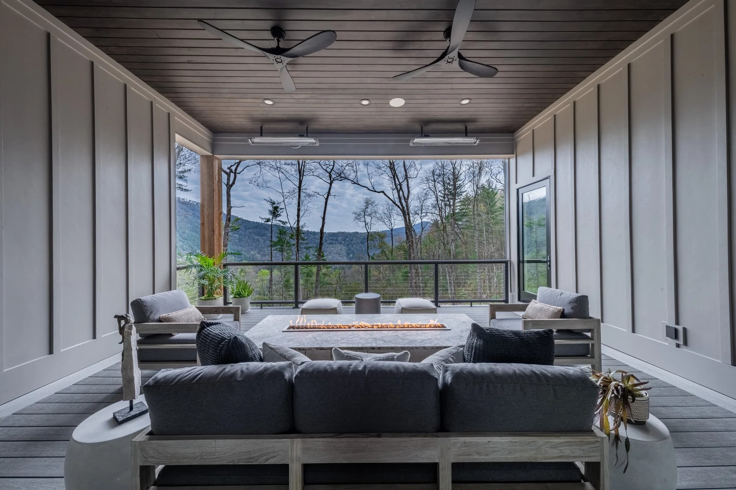 Covered porch with a fire feature, looking out over the mountains.