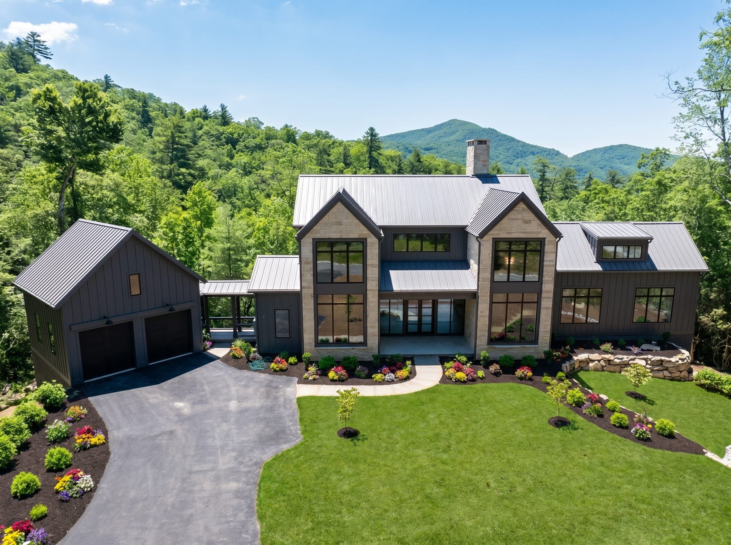 Mountain modern custom home at Saratay Falls in Cashiers, with a metal roof and stone entry.